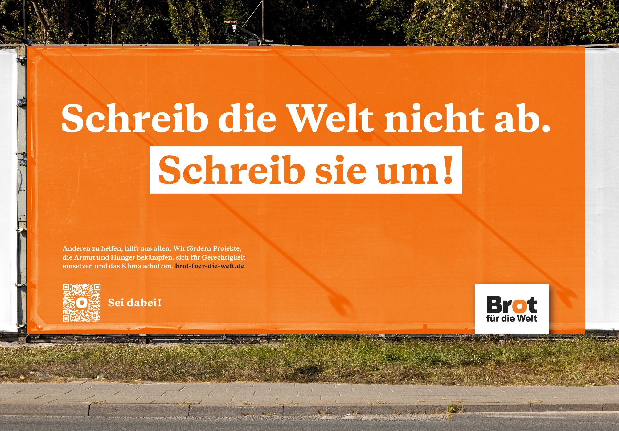 Bauzaunbanner „Schreib die Welt nicht ab. Schreib sie um!“